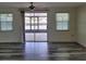 Living room boasts gray wood-look floors, access to lanai, and natural lighting at 5234 Forbes Ter, Port Charlotte, FL 33981