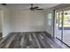 Spacious living room with wood-look flooring, neutral walls, and a ceiling fan at 5234 Forbes Ter, Port Charlotte, FL 33981