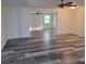 Bright living room featuring new gray wood-look flooring and neutral paint, creating a move-in ready space at 5234 Forbes Ter, Port Charlotte, FL 33981
