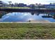 Waterfront with a seawall and calm water reflecting nearby houses and the clear blue sky above at 5234 Forbes Ter, Port Charlotte, FL 33981