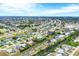 An aerial view of a tranquil neighborhood features waterfront homes along winding canals at 533 Boundary Blvd, Rotonda West, FL 33947