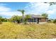 Spacious backyard showcasing a screened-in pool and ample green space at 533 Boundary Blvd, Rotonda West, FL 33947
