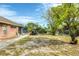Expansive backyard featuring a lush lawn, mature trees, and a sturdy chain-link fence at 533 Boundary Blvd, Rotonda West, FL 33947