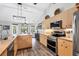 Bright kitchen with wood floors and cabinets, stainless steel appliances and eat-in breakfast nook at 533 Boundary Blvd, Rotonda West, FL 33947