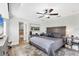 Spacious main bedroom with wood floors, a ceiling fan, and ensuite bath at 533 Boundary Blvd, Rotonda West, FL 33947