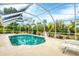 Refreshing screened pool area with lounge chairs for soaking up the sun and lush backyard views at 533 Boundary Blvd, Rotonda West, FL 33947