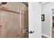 Shower with sliding glass door and light brown tile, and a view into an adjacent room at 533 Boundary Blvd, Rotonda West, FL 33947