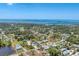 Beautiful aerial view of a charming coastal community with lush greenery and stunning ocean vistas in the background at 551 Morrison Ave, Englewood, FL 34223
