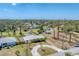 An aerial perspective reveals the property's well-maintained landscaping, circular driveway, and overall neighborhood setting at 551 Morrison Ave, Englewood, FL 34223