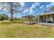 The spacious backyard features a deck with a pergola and a shed, perfect for outdoor entertaining and storage at 551 Morrison Ave, Englewood, FL 34223