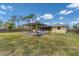 The backyard has a pergola-covered deck and screened-in porch, offering a comfortable outdoor living space at 551 Morrison Ave, Englewood, FL 34223