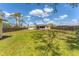 The spacious backyard offers a serene retreat with a pergola-covered deck and plenty of room for outdoor activities at 551 Morrison Ave, Englewood, FL 34223