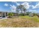 Large, grassy backyard with a pergola covered deck and storage shed at 551 Morrison Ave, Englewood, FL 34223