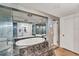 Bathroom features a soaking tub with tile surround and large vanity with mirrored wall at 551 Morrison Ave, Englewood, FL 34223