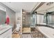 A bathroom with a glass enclosed shower, soaking tub, tile accents and modern fixtures at 551 Morrison Ave, Englewood, FL 34223
