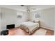 Bright bedroom features two windows and a ceiling fan above a cozy bed at 551 Morrison Ave, Englewood, FL 34223