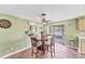 Charming dining area with a wooden table and chairs, complemented by natural light and stylish decor at 551 Morrison Ave, Englewood, FL 34223
