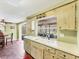 Bright eat-in kitchen with a view to the lanai through the window above the sink and stainless-steel appliances at 551 Morrison Ave, Englewood, FL 34223