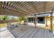 Outdoor patio has a pergola over a seating area, providing a shaded space for relaxing and enjoying the backyard at 551 Morrison Ave, Englewood, FL 34223