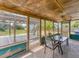 Relaxing screened in porch with a ceiling fan and views of the backyard at 551 Morrison Ave, Englewood, FL 34223