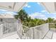 Outdoor balcony with white railings and tropical landscaping views at 5856 Gasparilla Rd # Mv26, Boca Grande, FL 33921