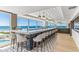 Upscale beachfront bar with sleek countertops, comfortable seating, modern lighting, and panoramic ocean views at 5856 Gasparilla Rd # Mv26, Boca Grande, FL 33921