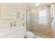 Shower room with sliding glass door, vanity sink, and towel rack at 5856 Gasparilla Rd # Mv26, Boca Grande, FL 33921