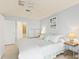 Serene bedroom featuring soft blue walls, a plush bed, and access to an ensuite bathroom at 5856 Gasparilla Rd # Mv26, Boca Grande, FL 33921