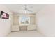 Bedroom featuring built-in shelving surrounding a window with natural light and ceiling fan at 5856 Gasparilla Rd # Mv26, Boca Grande, FL 33921