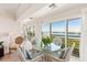 Cozy dining area with water views and a glass-topped table, perfect for enjoying waterfront scenery at 5856 Gasparilla Rd # Mv26, Boca Grande, FL 33921