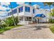 Beautiful bright white multi-story coastal home featuring a covered entryway and brick driveway, perfect for seaside living at 5856 Gasparilla Rd # Mv26, Boca Grande, FL 33921