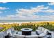 Relaxing outdoor seating area with a modern fire pit and comfortable seating, offering stunning views of the beach at 5856 Gasparilla Rd # Mv26, Boca Grande, FL 33921