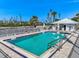 Outdoor swimming pool with poolside furniture and blue sky views at 5856 Gasparilla Rd # Mv26, Boca Grande, FL 33921