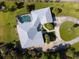 Aerial view of the home featuring a screened pool and lush landscaping at 60 N Oxford Dr, Englewood, FL 34223