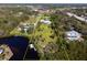 Aerial view of property including home, large yard, and waterfront access at 60 N Oxford Dr, Englewood, FL 34223