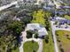 Expansive property with a circular driveway, lush lawn, private pool, and an oversized driveway for boat parking at 60 N Oxford Dr, Englewood, FL 34223