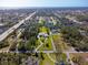 Aerial view shows property including home, yard, and neighborhood canal at 60 N Oxford Dr, Englewood, FL 34223