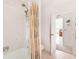 Bathroom featuring neutral tile, a tub, and a shower with lavender-themed curtain at 60 N Oxford Dr, Englewood, FL 34223