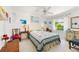 Cozy bedroom featuring natural light, a ceiling fan and a charming vintage-style decor at 60 N Oxford Dr, Englewood, FL 34223