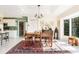 Elegant dining room with modern lighting, a large window, and views of the backyard at 60 N Oxford Dr, Englewood, FL 34223