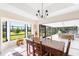 Sunlit dining room with large windows offering scenic views and an open-concept layout at 60 N Oxford Dr, Englewood, FL 34223