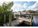 Boat on a dock overlooking canal waters, blending leisure with a scenic backdrop at 60 N Oxford Dr, Englewood, FL 34223