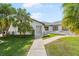 Welcoming home featuring a modern white exterior, mature landscaping, and a cozy entryway at 60 N Oxford Dr, Englewood, FL 34223