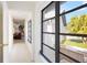 Hallway with view to front yard, living room, and bedroom at 60 N Oxford Dr, Englewood, FL 34223