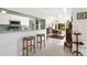 Open-concept kitchen with breakfast bar, white cabinetry, and views into the dining area at 60 N Oxford Dr, Englewood, FL 34223