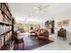 Large living room featuring bright lighting, bookshelves and a large area rug at 60 N Oxford Dr, Englewood, FL 34223