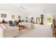 Bright living room with white walls, ceiling fans, neutral furniture, and large windows at 60 N Oxford Dr, Englewood, FL 34223
