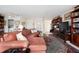 Living room featuring bright lighting, bookshelves and a large area rug at 60 N Oxford Dr, Englewood, FL 34223