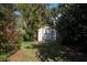 Storage shed in the backyard surrounded by foliage, providing outdoor storage space at 60 N Oxford Dr, Englewood, FL 34223