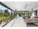 Bright sunroom featuring outdoor views and neutral furniture that provides an excellent indoor/outdoor living space at 60 N Oxford Dr, Englewood, FL 34223